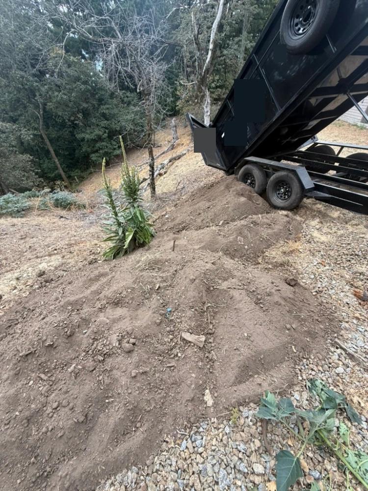 Dump trailer tipping a load of dirt